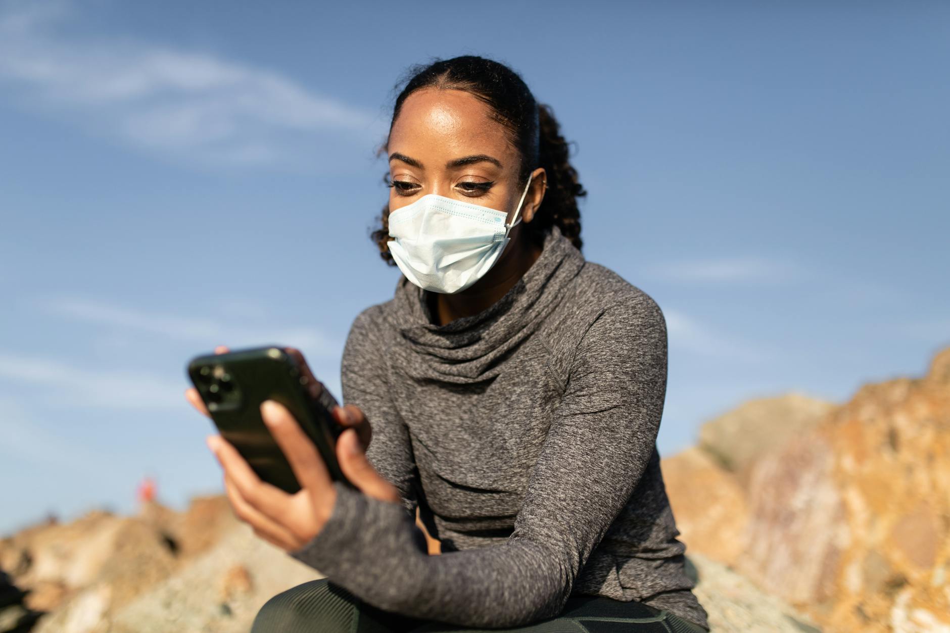 https://www.pexels.com/photo/a-woman-in-a-face-mask-using-her-smartphone-4909475/